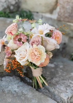 Dusty pink bridal bouquet on steps