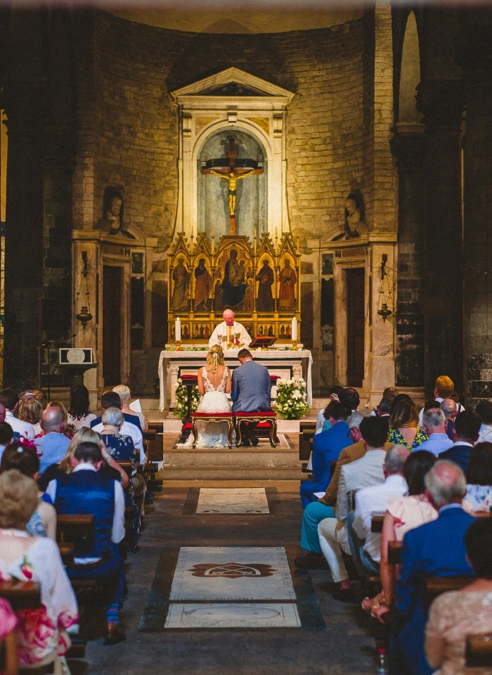 Bride and groom pray during catholic wedding ceremony in a Florence church