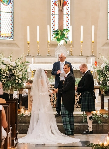 Bride and groom stand at the altar for a protestant wedding in a church in Tuscany