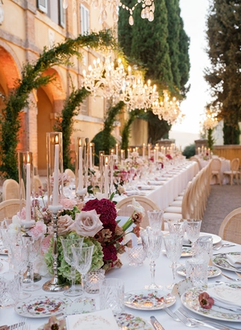 Side view of floral wedding reception with crystal chandeliers at La Foce