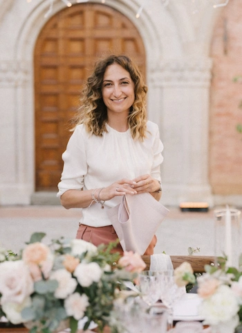 Destination wedding planner Sara Barni folding a napkin
