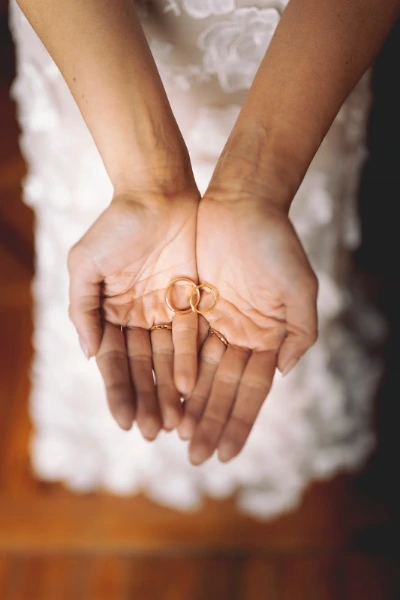 Close up picture of bride holding wedding bands in her hands in preparatio of wedding ceremony