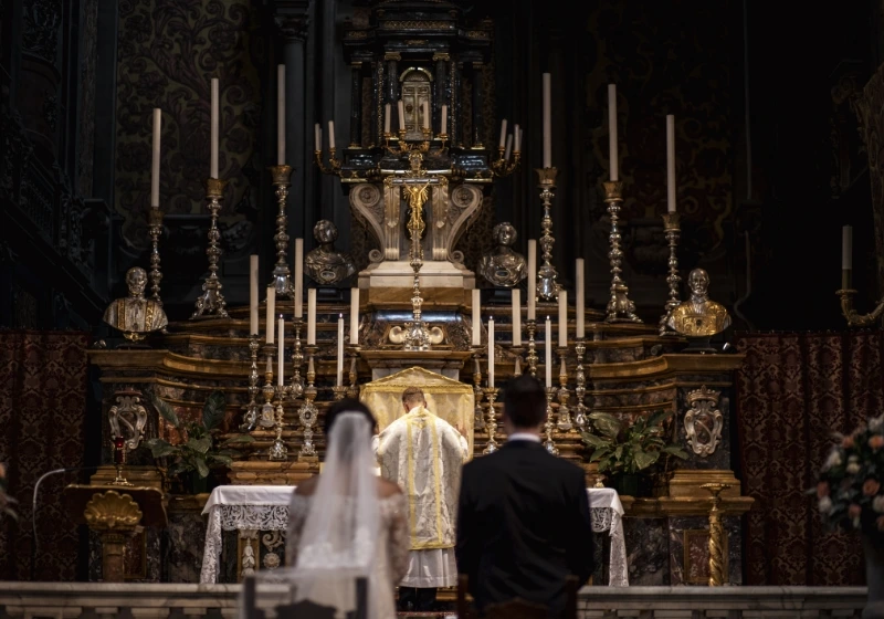 Groom and bride getting married in church in Italy during catholic wedding ceremony