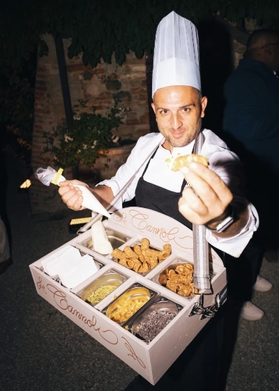 Pastry chef entertains guests with live show cooking cannoli and personalized toppings 