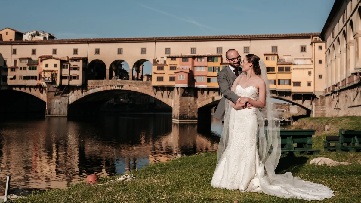 Couple shot of UK newlyweds in front of Ponte Vecchio after civil wedding ceremony in Florence