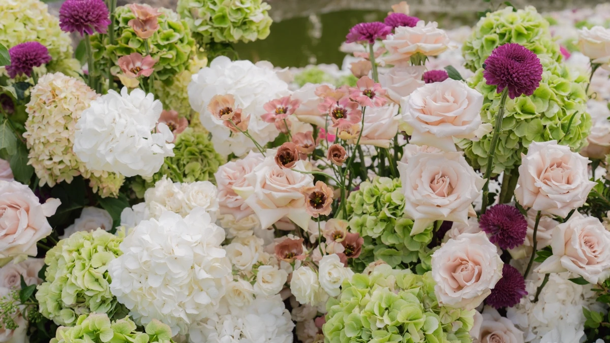 Close up of outdoor wedding ceremony floral decoration with mix of pink, green and white flowers