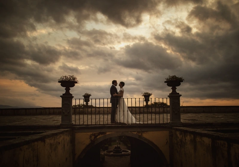 Outdoor shot of bride and groom standing on balcony on a fall wedding day