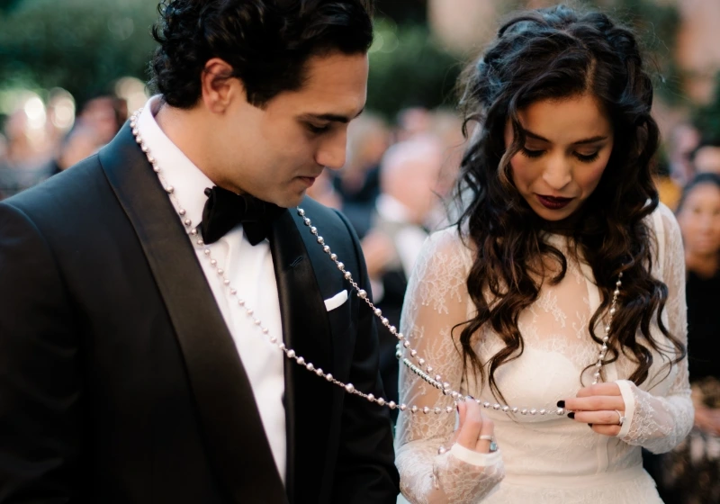 Bride and groom perform el lasso ritual during symbolic wedding ceremony in Tuscany