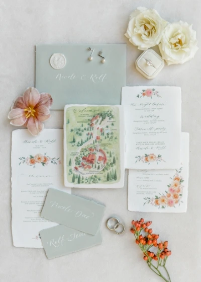 Details shot of green and white wedding stationery with hand drawn picture of wedding venue in Tuscany