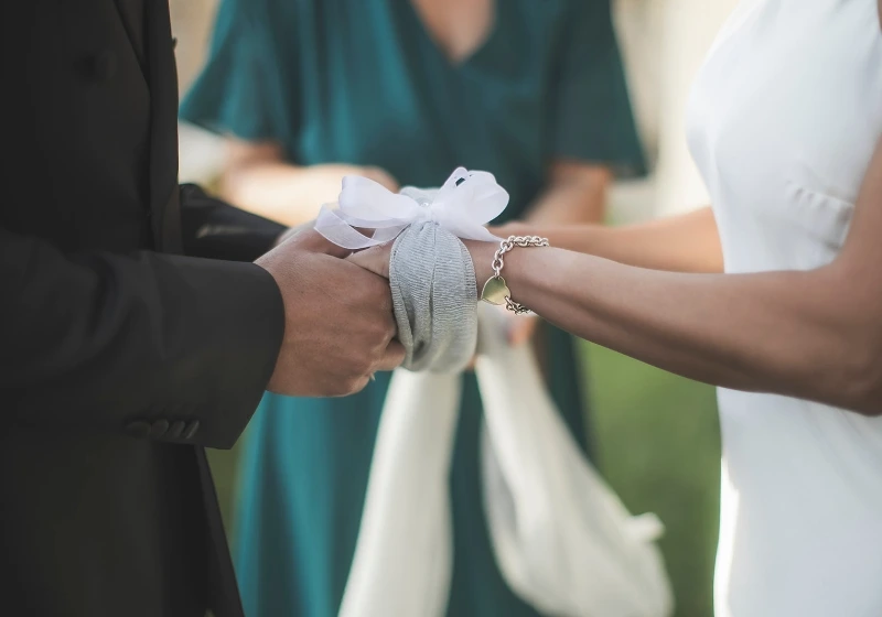 Detail shot of handfasting ritual during symbolic wedding ceremony in Tuscany