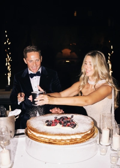 Newlyweds participate in the live showcooking of the Millefoglie wedding cake with sparklers going off in the backround 