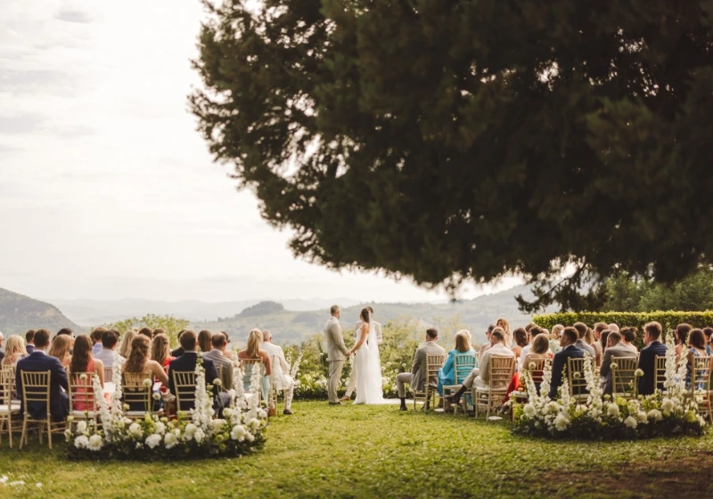 White and green outdoor wedding ceremony at Villa di Ulignano in Volterra, Tuscany