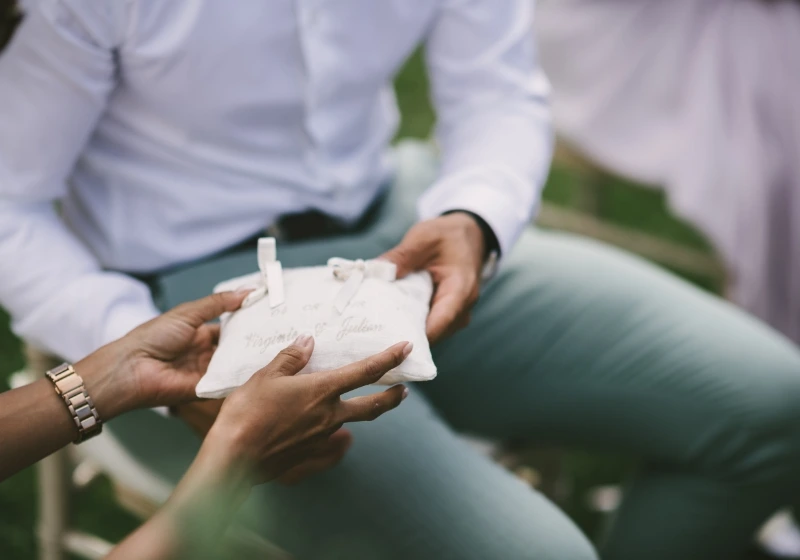 Details shot of rings being passed around during ring warming ritual during symbolic wedding ceremony 