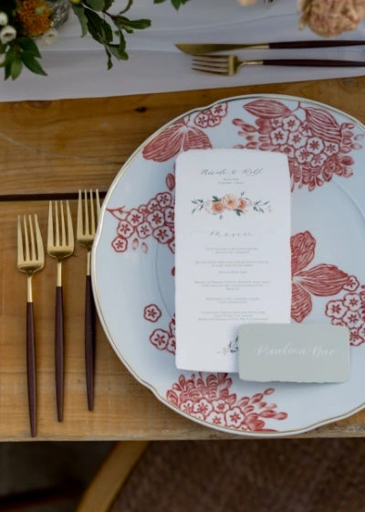 Close up of wedding table mise en place featuring an oriental theme set up in orange color