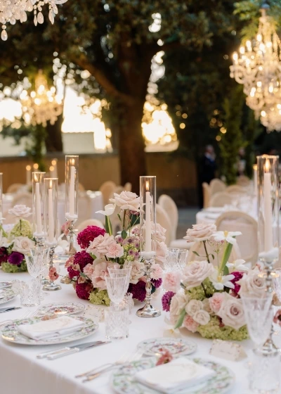 Close up of dinner set up for romantic wedding at La Foce with flower centerpieces and floral plates