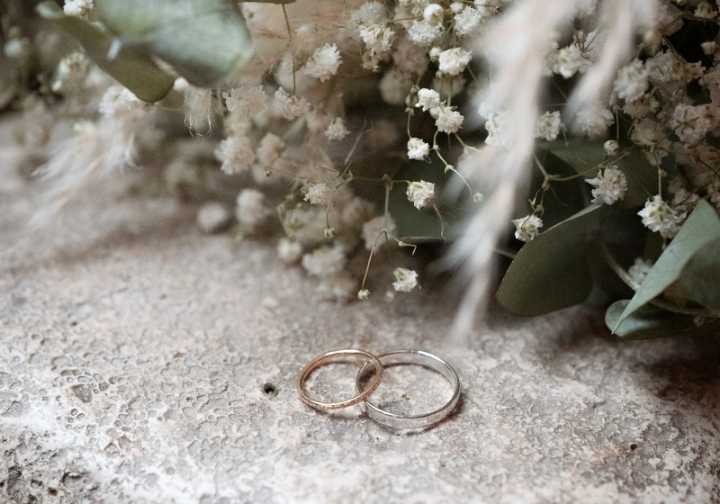 Detail shot of wedding bands with bouquet of baby's breath used for civil wedding of Australian citizens in Tuscany