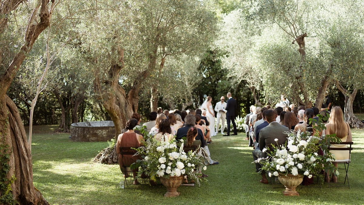 Wedding ceremony in between olive trees for a destination wedding in Tuscany