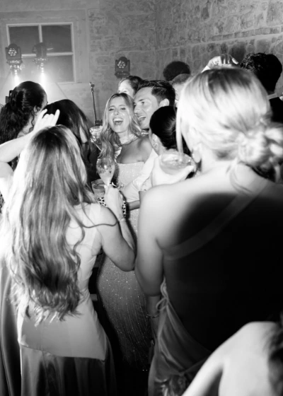 Wedding guests have fun with bride and groom during party in the lemon house of La Foce 