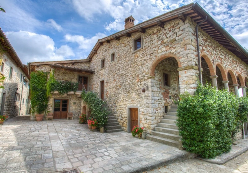 The stone facade of Borgo Corsignano, a Tuscan hamlet for weddings immersed in the Casentino countryside.