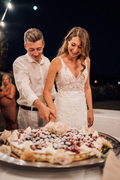 Photo of bride and groom cutting the wedding cake