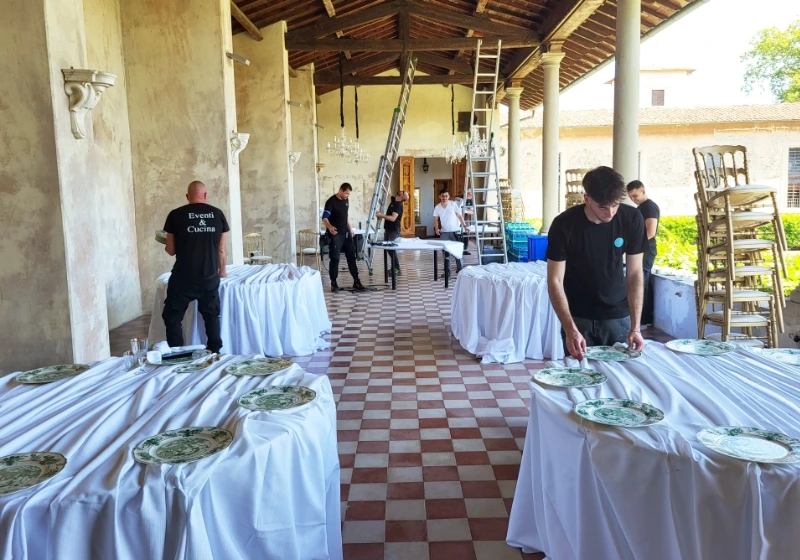 A catering setting up a wedding dinner in tuscany