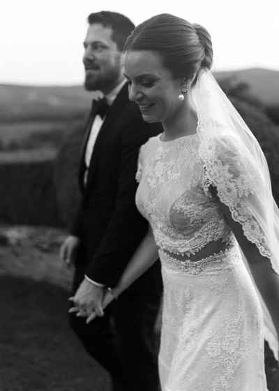 Fine art photo of bride and groom walking 