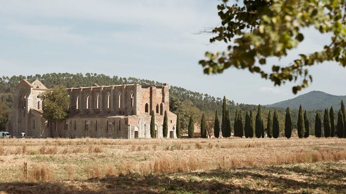 San Galgano Abbey surrounded by the landscape of the Tuscan countryside.