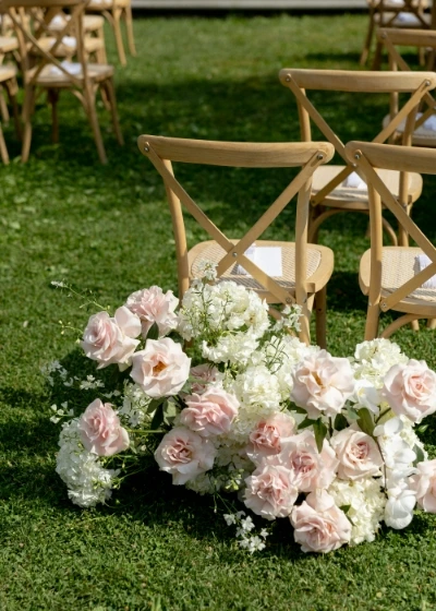Seasonal wedding flowers arranged in reusable arrangements in Tuscany