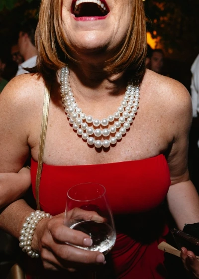 A wedding guest enjoing a drink during the party 